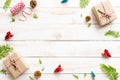 Top view of Gift box, pine cones, red star and bell on a wooden white background. Royalty Free Stock Photo