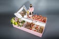 Top view of gift boxes and delicious candies, snacks, sweets, wine and chocolate pieces on black
