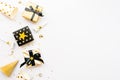 Top view of gift boxes and party accessories in various black, white and golden designs. Flat lay, copy space. A concept of Royalty Free Stock Photo