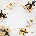 Top view of gift boxes in various black, white and golden designs, shining ligts wire and golden stars. Flat lay, copy space. A Royalty Free Stock Photo