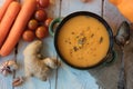 Top view of ginger carrot cream soup on white surface. Royalty Free Stock Photo
