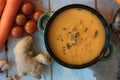 Top view of ginger carrot cream soup on white surface. Royalty Free Stock Photo