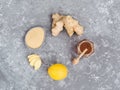 Top view of ginger slice, ginger root, ginder powder, lemon and honey