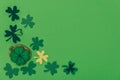 top view of gingerbread in shape of shamrock and paper shamrock isolated on green, st patricks day concept