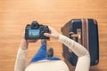 Top view on a girl looking a photos Chicago city on her camera standing with suitcase in the airport. The girl returns home after Royalty Free Stock Photo