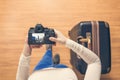 Top view on a girl looking a photos Chicago city on her camera standing with suitcase in the airport. The girl returns home after Royalty Free Stock Photo