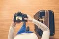 Top view on a girl looking a photos of fresh coconut juice on her camera standing with suitcase in the airport. The girl returns h Royalty Free Stock Photo