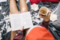 Top view of girl with naked legs reading a book Royalty Free Stock Photo