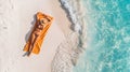 top view of a girl sunbathing on an orange towel in a hat on the beach near a dynamic sea clean transparent blue wave. banner with Royalty Free Stock Photo