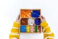 Top view of girls hand is sorting a puzzle of colored plastic beads in montessori school Royalty Free Stock Photo