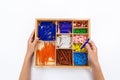 Top view of girls hand is sorting a puzzle of colored plastic beads in montessori school Royalty Free Stock Photo