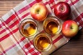 top view of a glass of apple cider vinegar on a checkered tablecloth Royalty Free Stock Photo