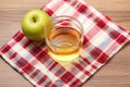 top view of a glass of apple cider vinegar on a checkered tablecloth Royalty Free Stock Photo