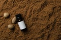 Top view of glass bottle of essential oil, nutmegs, cocoa powder.Empty space.Natural ingredients for beauty products