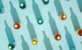 Top view of glass bottles with metal caps standing on turquoise blue background Royalty Free Stock Photo