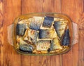 Baked mackerel in glass casserole pan on old rustic table Royalty Free Stock Photo