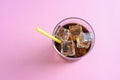 Top view of a glass of cola with ice cubes on pink background Royalty Free Stock Photo