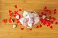 Top view of glass double walls cup of coffee with marshmallow. On the wooden table with red paper hearts and candies. Royalty Free Stock Photo