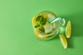 Refreshing natural non-alcoholic cocktail in glass jar with ice cubes, slices of lime and lemon, sprig of mint with Royalty Free Stock Photo