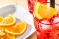 Top of view of glass of spritz aperitif aperol cocktail with orange slices and ice cubes