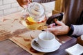 Top view of glass teapot and cups of tea on a table at restaurant close up. Tea ceremony. Holiday concept. Hot winter drink