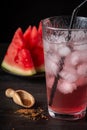 Top view of glass of watermelon juice with ice, on table with brown sugar Royalty Free Stock Photo