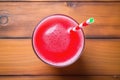 top view of a glass of watermelon juice with a straw