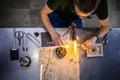 Glassblowing Young Man Working on a Torch Flame with Glass Tubes