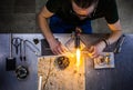 Glassblowing Young Man Working on a Torch Flame with Glass Tubes