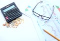 Top view a glasses,pencil, money, calculator and chart or graph on office desk table.Finance and business concept. Royalty Free Stock Photo