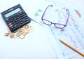 Top view a glasses,pencil, money, calculator and chart or graph on office desk table.Finance and business concept. Royalty Free Stock Photo