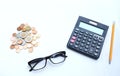 Top view a glasses,pencil, money, calculator and chart or graph on office desk table.Finance and business concept. Royalty Free Stock Photo