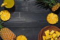 Top view of glasses of pineapple juice and pineapple fruit on a