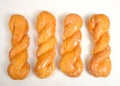 Top view of glazed twist donuts in row on parchment paper Royalty Free Stock Photo