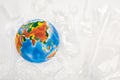 Top view of globe on plastic garbage on white background, global warming concept