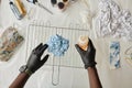 Top view of gloved hands of craftsman with plastic bottle of dye Royalty Free Stock Photo