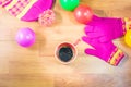 Top view gloves, Silk hat, colored balls and a cup of coffee on wood table. In the winter. Royalty Free Stock Photo