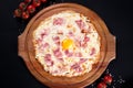 Top view gluten Free Pizza Carbonara with Bacon and Yolk of Chicken Egg and cherry tomatoes. Homemade food. Concept for a tasty