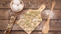 Top view of Gnocchis on a wooden dock with flour on them