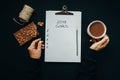 Top view 2018 goals list with woman hands, pencil, chocolate, co Royalty Free Stock Photo