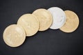 Top view on gold coins of Bitcoin, Litecoin and Ethereum on black background