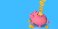 Top view of gold coins falling inside pink ceramic piggy bank standing against blue background Royalty Free Stock Photo