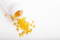 Top view of Gold fish oil scattered from pill bottle isolated for good health on white background. Supplementary food. Omega 3. Royalty Free Stock Photo