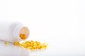 Top view of Gold fish oil scattered from pill bottle isolated for good health on white background. Supplementary food. Omega 3. Royalty Free Stock Photo