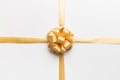 Top view of gold ribbon rolled and yellow bow isolated on colored background. Flat lay with copy space Royalty Free Stock Photo