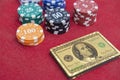 Top view of golden 100 dollar playing cards next to stacks of chips on red felt table Royalty Free Stock Photo