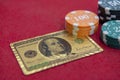 Top view of golden 100 dollar playing cards next to stacks of chips on red felt table Royalty Free Stock Photo