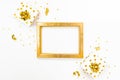 Top view of golden dotted gift boxes and golden empty frame on a white background. Copy space, mock-up