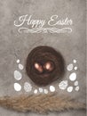 top view of golden easter eggs in nest on concrete surface with Happy