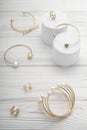 Top view of golden girl accessories bracelets and rings collection on wooden background Royalty Free Stock Photo